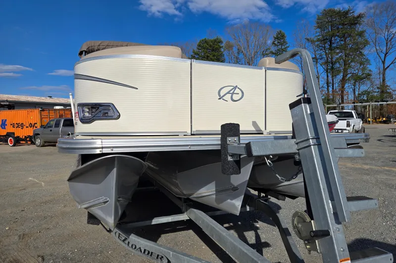 Slide: The Image of 2020 Avalon LSZ VRB 24' pontoon boat on trailer, parked outdoors. - 4