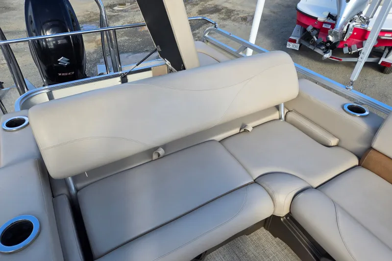 Slide: The Image of 2020 Avalon LSZ VRB 24' boat interior with beige seating and cup holders. - 40