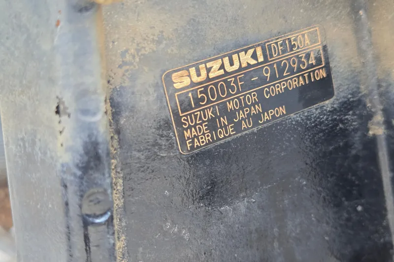 Slide: The Image of Close-up of a Suzuki motor label, model DF150A, made in Japan. - 55