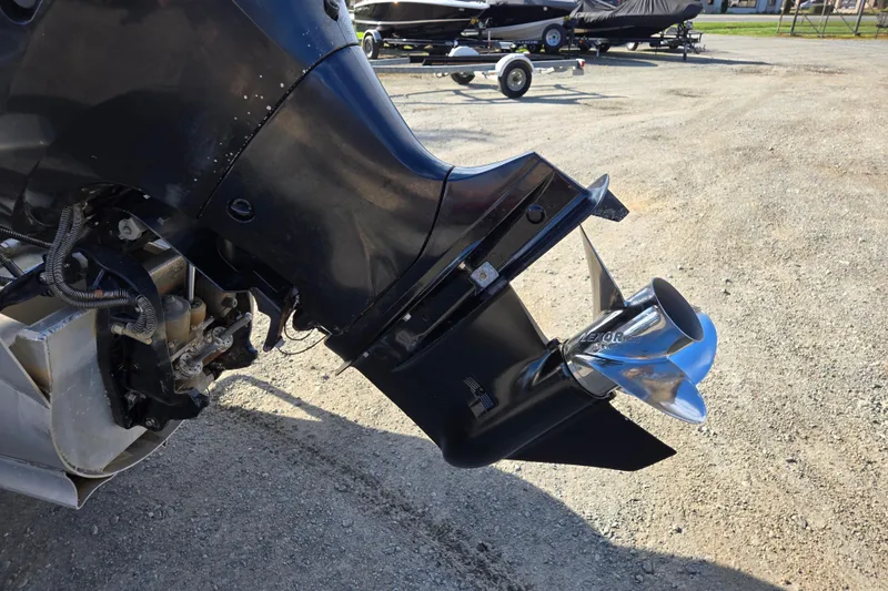 Slide: The Image of Outboard motor of 2020 Avalon LSZ VRB - 24' pontoon boat on gravel surface. - 6