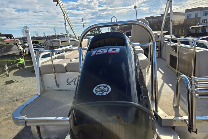Slide: The Image of 2020 Avalon LSZ VRB 24' pontoon boat with 150 HP engine, docked under blue sky. - 8