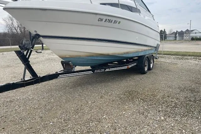 Slide: The Image of 1997 Bayliner 2355 boat on trailer, parked on gravel lot. - 4