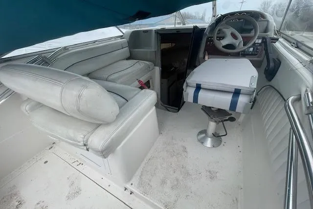 Slide: The Image of 1997 Bayliner 2355 boat interior with white seating and steering area. - 6