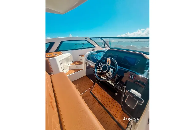 Slide: The Image of Luxurious 2026 NX Boats NX340 cockpit with modern steering and navigation system. - 10