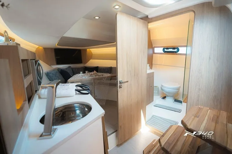 Slide: The Image of Luxurious interior of 2026 NX Boats NX340, featuring modern amenities and elegant wood finishes. - 14