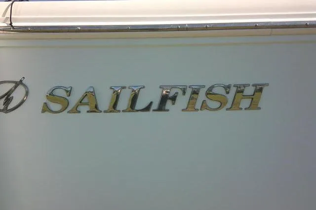 Slide: The Image of 2017 Sailfish 240 CC boat logo on white hull. - 13