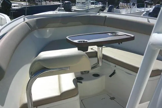 Slide: The Image of 2017 Sailfish 240 CC boat interior with seating and table setup. - 14