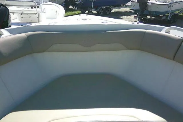 Slide: The Image of Interior view of a 2017 Sailfish 240 CC boat, featuring cushioned seating. - 15