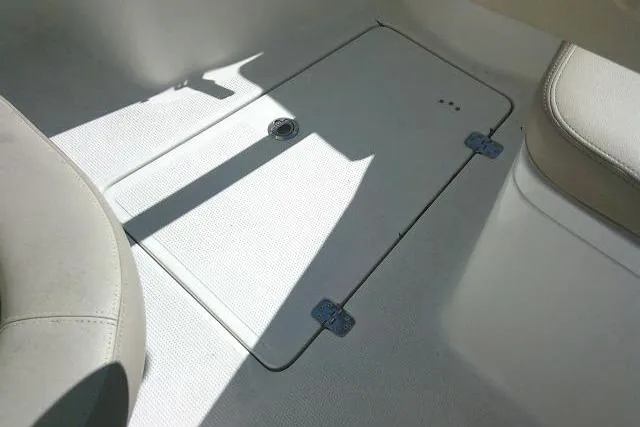 Slide: The Image of 2017 Sailfish 240 CC boat deck with storage hatch and seating. - 18