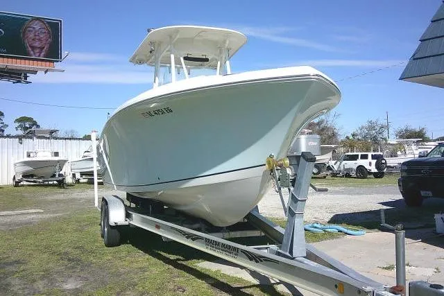Slide: The Image of 2017 Sailfish 240 CC boat on trailer in outdoor setting. - 2