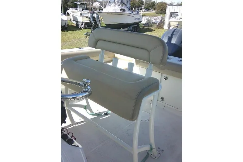 Slide: The Image of 2017 Sailfish 240 CC boat seat with beige upholstery and chrome accents. - 22