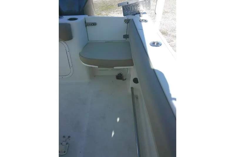 Slide: The Image of Interior view of a 2017 Sailfish 240 CC boat, featuring seating and cup holders. - 23