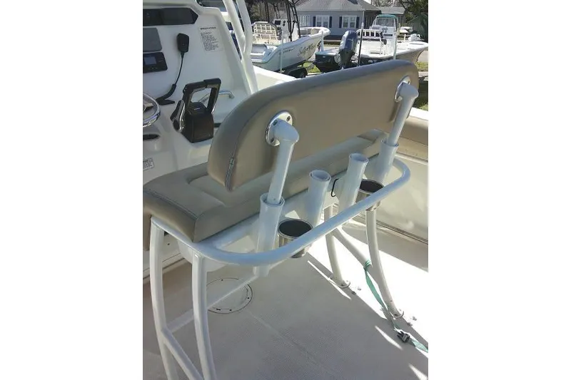 Slide: The Image of 2017 Sailfish 240 CC boat interior with cushioned seating and rod holders. - 26