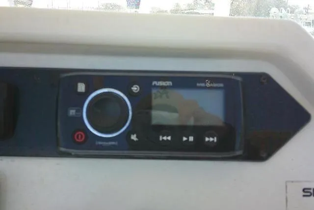 Slide: The Image of Fusion marine stereo system on a 2017 Sailfish 240 CC boat dashboard. - 29