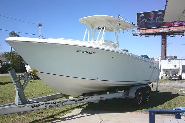 Slide: The Image of 2017 Sailfish 240 CC boat on trailer, parked outdoors under clear blue sky. - 3
