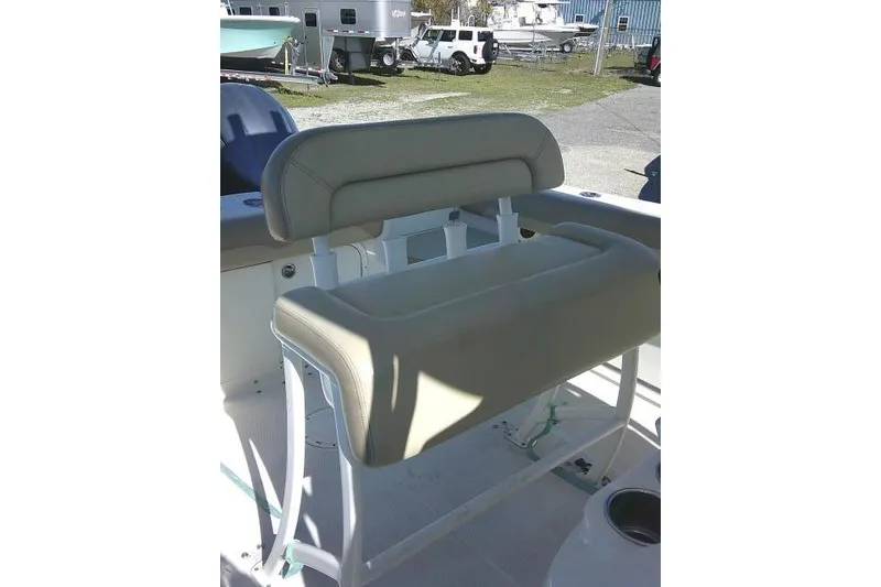 Slide: The Image of 2017 Sailfish 240 CC boat seat with beige upholstery in outdoor setting. - 32
