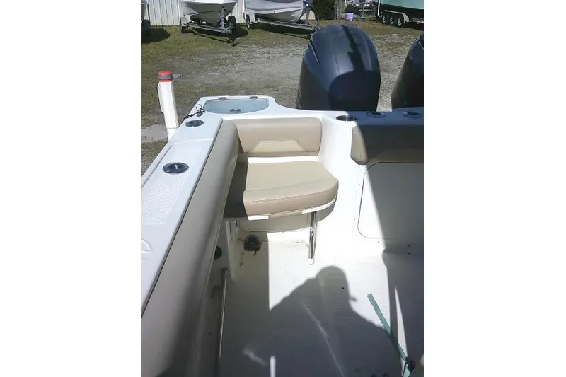 Slide: The Image of 2017 Sailfish 240 CC boat interior with seating and dual engines. - 33