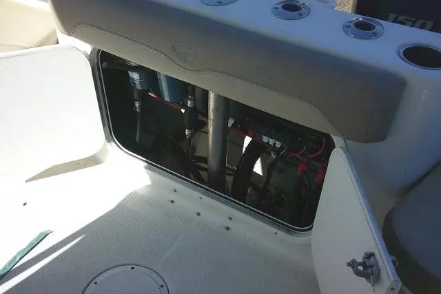 Slide: The Image of 2017 Sailfish 240 CC boat storage compartment with open hatch and visible wiring. - 41