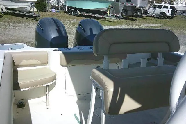 Slide: The Image of 2017 Sailfish 240 CC boat interior with dual engines and beige seating. - 42