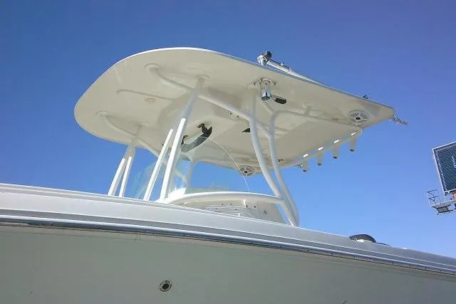 Slide: The Image of 2017 Sailfish 240 CC boat with T-top against clear blue sky. - 7