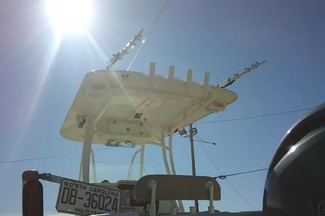 Slide: The Image of 2017 Sailfish 240 CC boat under bright sun, North Carolina license plate visible. - 8