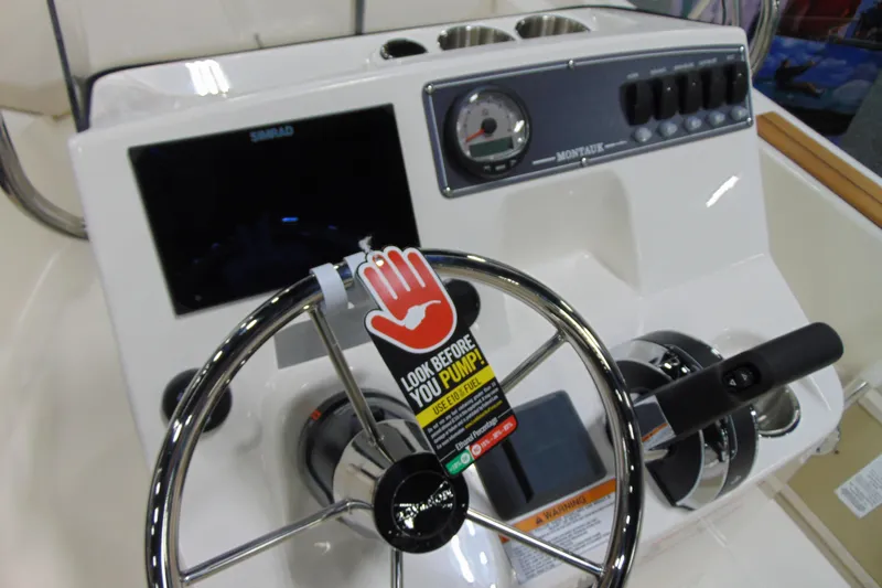 Slide: The Image of 2026 Boston Whaler 170 Montauk dashboard with steering wheel and control panel. - 10