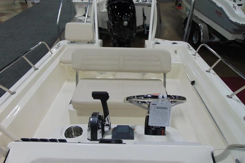 Slide: The Image of 2026 Boston Whaler 170 Montauk boat interior with steering wheel and seating. - 12