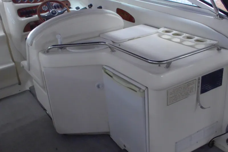 Slide: The Image of 1997 Sea Ray 280 Cuddy Cabin interior with helm, seating, and storage. - 4