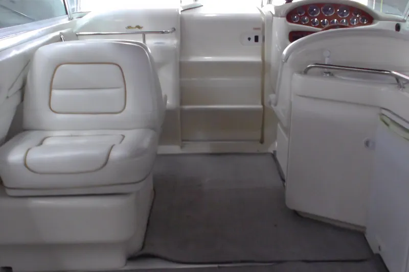 Slide: The Image of 1997 Sea Ray 280 Cuddy Cabin interior with white seating and dashboard. - 6