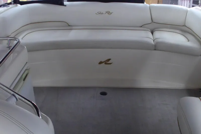 Slide: The Image of 1997 Sea Ray 280 Cuddy Cabin interior with white seating and logo. - 8