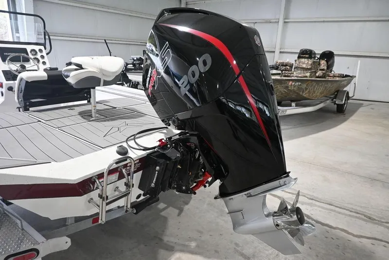 Slide: The Image of 2023 Vexus AVX2180CC boat with powerful outboard motor in a showroom setting. - 3