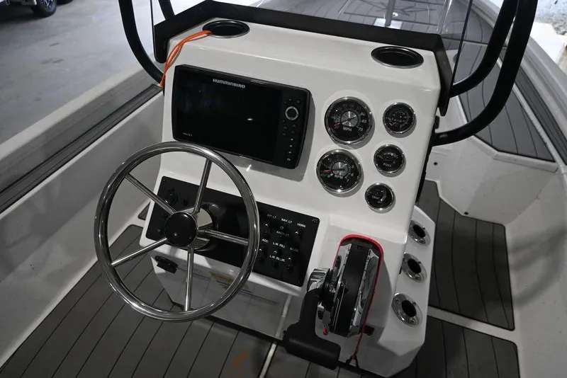 Slide: The Image of 2023 Vexus AVX2180CC boat console with steering wheel, gauges, and controls. - 5