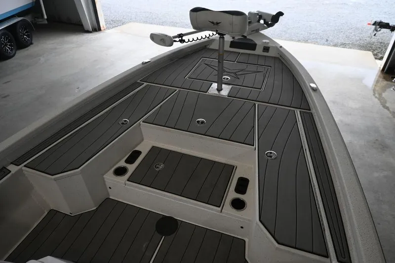 Slide: The Image of 2023 Vexus AVX2180CC boat interior with sleek deck design in a garage setting. - 6