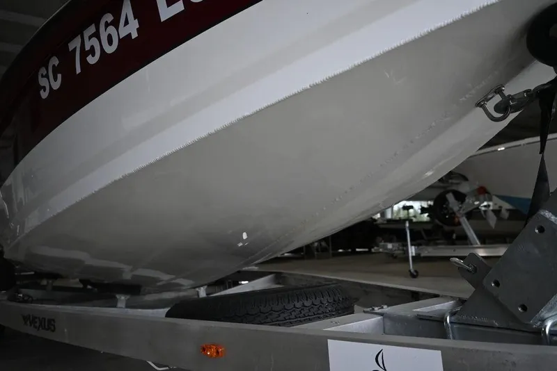 Slide: The Image of 2023 Vexus AVX2180CC boat on trailer, close-up view of hull and registration number. - 7