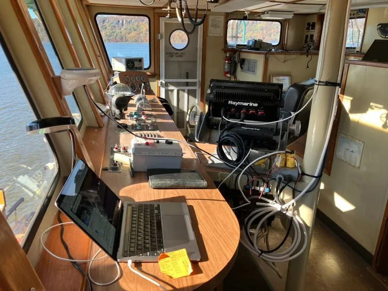 Slide: The Image of 1981 custom lift boat interior with navigation equipment and laptop on control panel. - 10