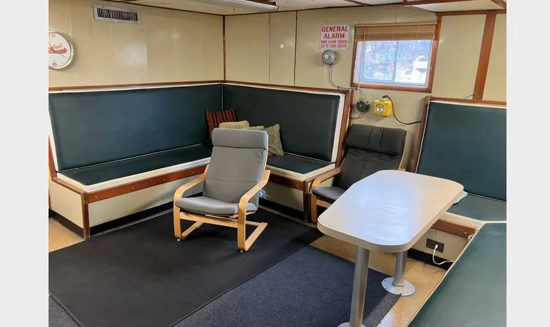 Slide: The Image of Interior of a 1981 custom lift boat with seating and table. - 16