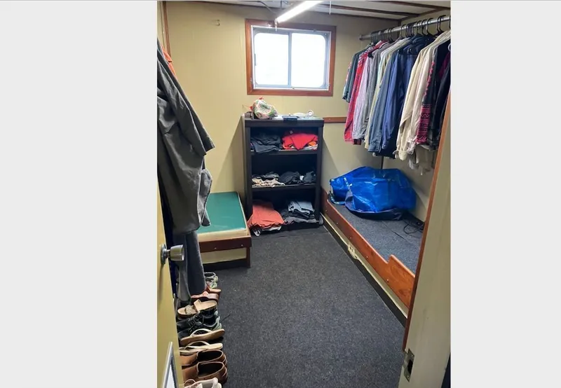 Slide: The Image of 1981 Custom Lift Boat bathroom with dual sinks, mirrors, and ocean view through glass door. - 18