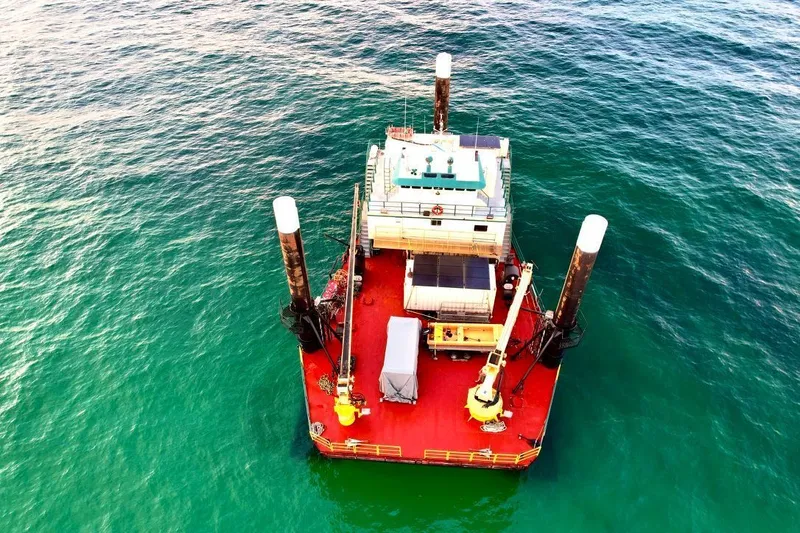 Slide: The Image of Aerial view of a 1981 custom lift boat on calm ocean waters. - 5