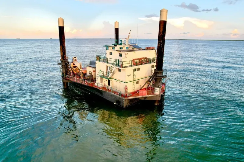 Slide: The Image of Custom 1981 lift boat on calm ocean waters at sunset. - 6