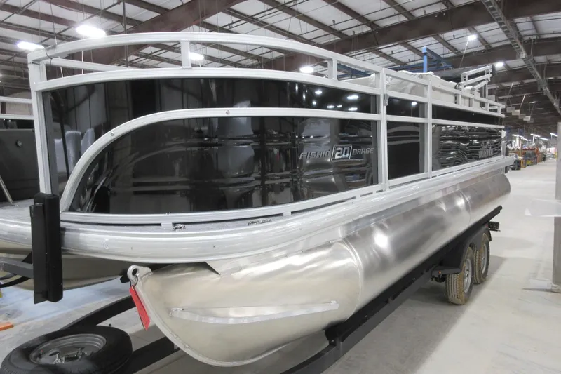 The Image of 2026 Sun Tracker Fishin' Barge 20 DLX pontoon boat in a warehouse setting. - 0