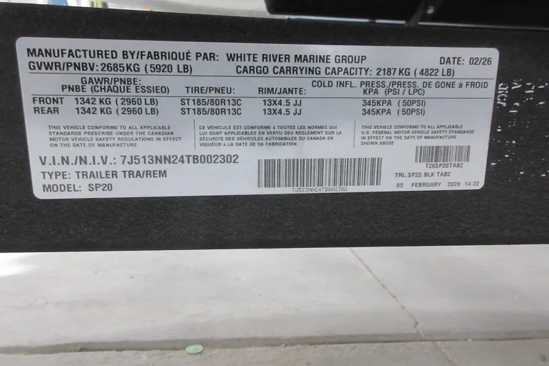 Slide: The Image of Label on Sun Tracker Fishin' Barge 20 DLX trailer, detailing specifications and compliance information. - 7