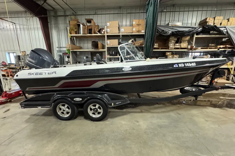 The Image of 2012 Skeeter WX2100 boat on trailer in a storage facility. - 0