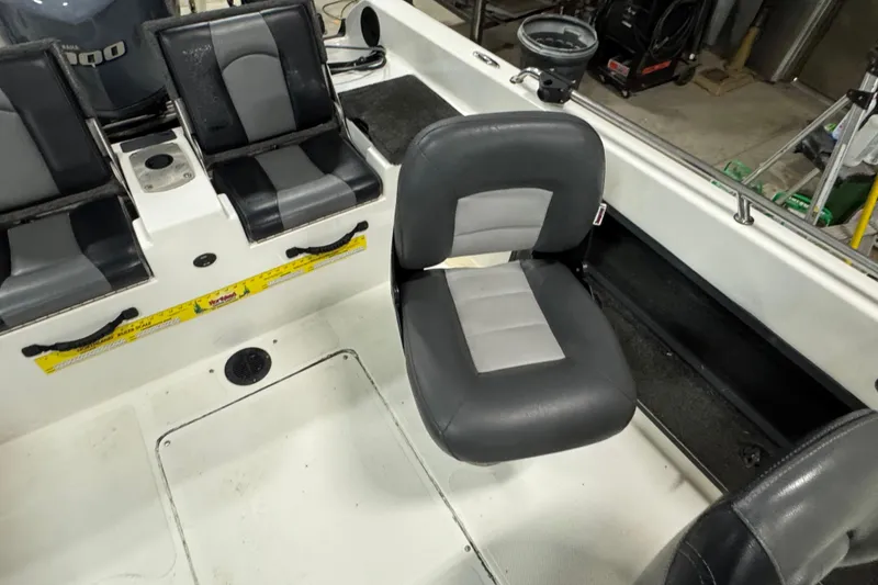 Slide: The Image of Interior of a 2012 Skeeter WX2100 boat with gray seating and equipment. - 10