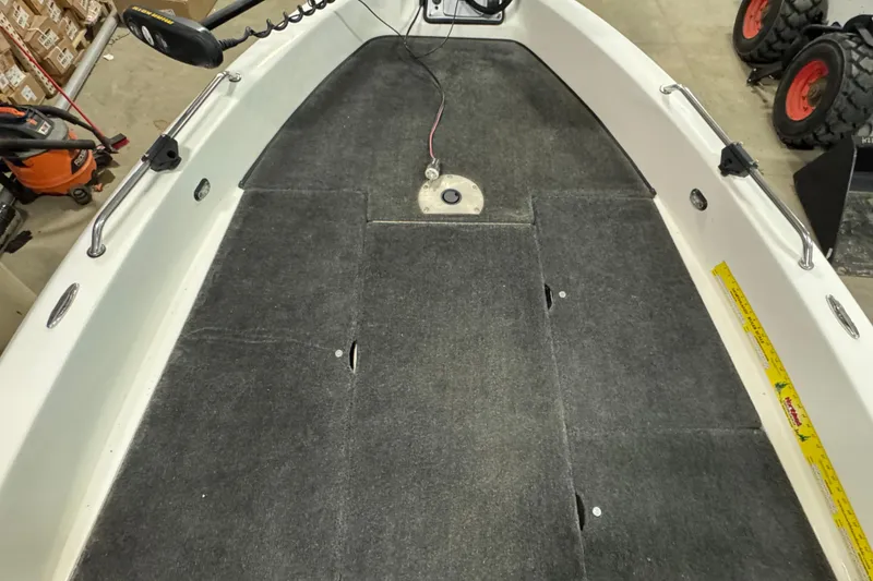 Slide: The Image of 2012 Skeeter WX2100 boat interior with carpeted deck and mounted equipment. - 13