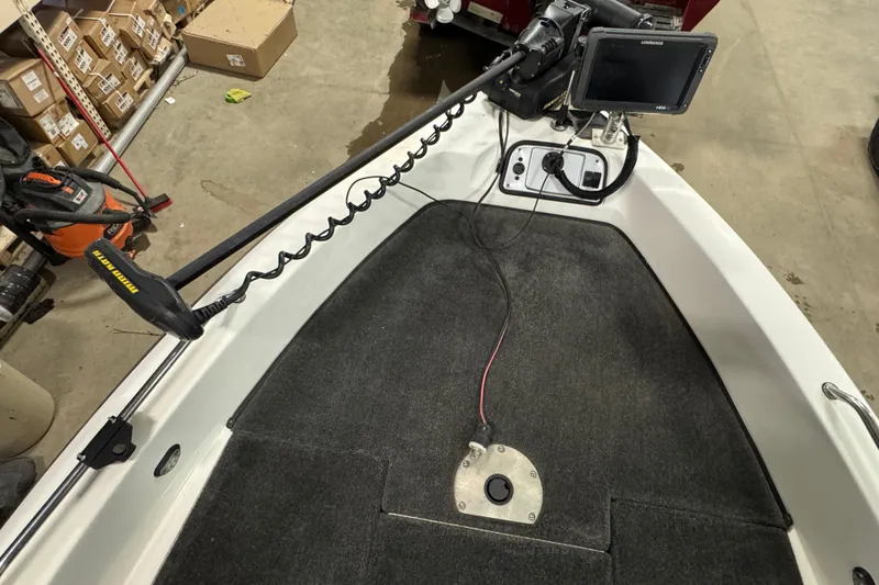 Slide: The Image of 2012 Skeeter WX2100 boat deck with trolling motor and fish finder in a garage. - 14