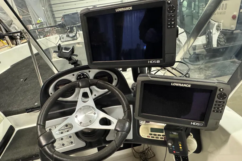 Slide: The Image of 2012 Skeeter WX2100 boat dashboard with Lowrance HDS displays and steering wheel. - 7