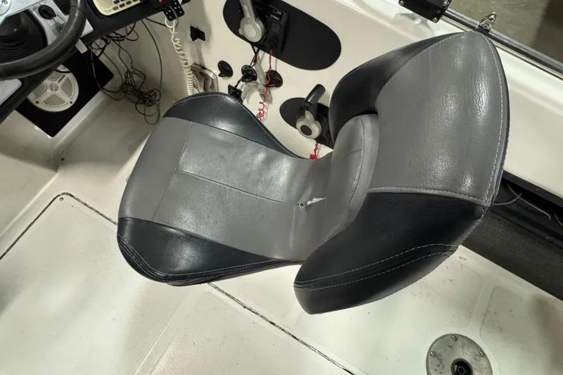 Slide: The Image of Skeeter WX2100 2012 boat interior with gray and black captain's chair. - 8