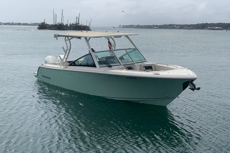 The Image of 2023 Sailfish 276 DC boat on calm water, overcast sky in the background. - 0