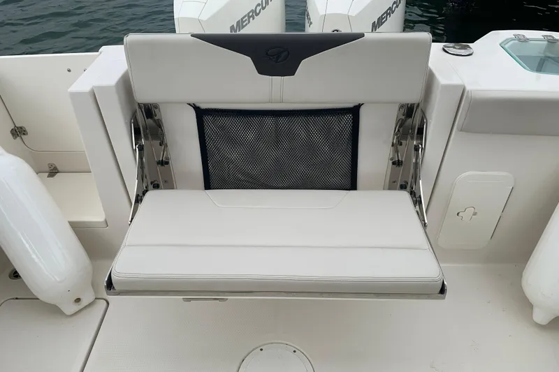 Slide: The Image of 2023 Sailfish 276 DC boat seat with storage net, featuring dual Mercury engines. - 16