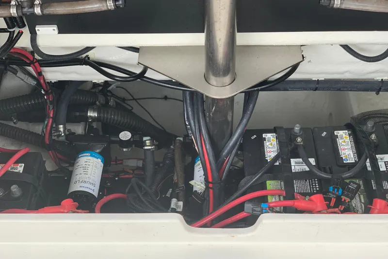 Slide: The Image of 2023 Sailfish 276 DC boat engine compartment with batteries and wiring. - 17